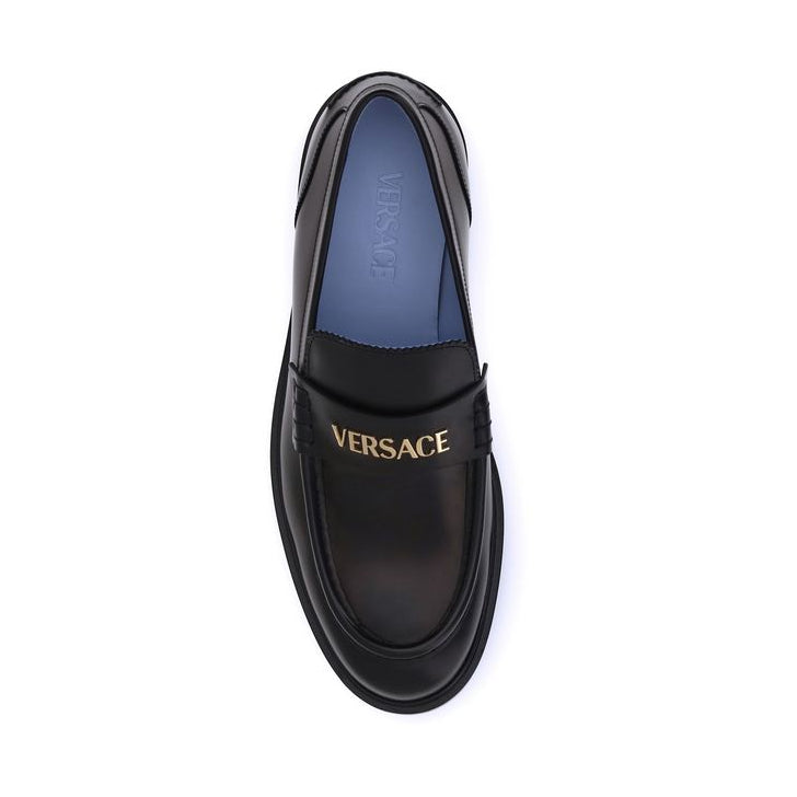Black Versace loafer on a white background