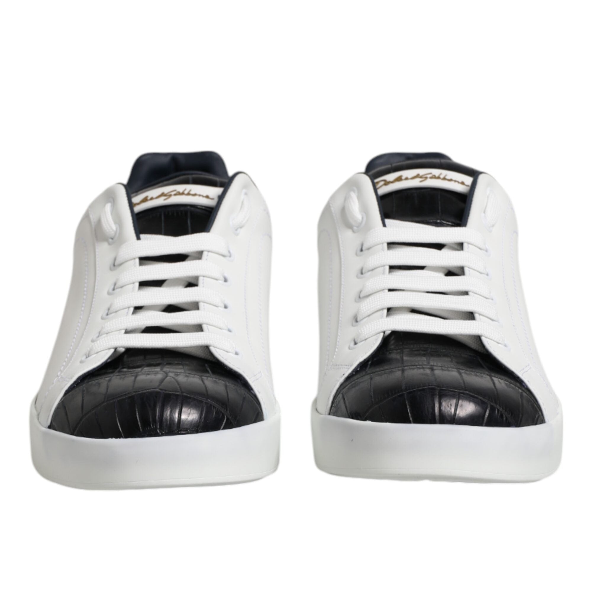 White sneakers with black soles on a white background