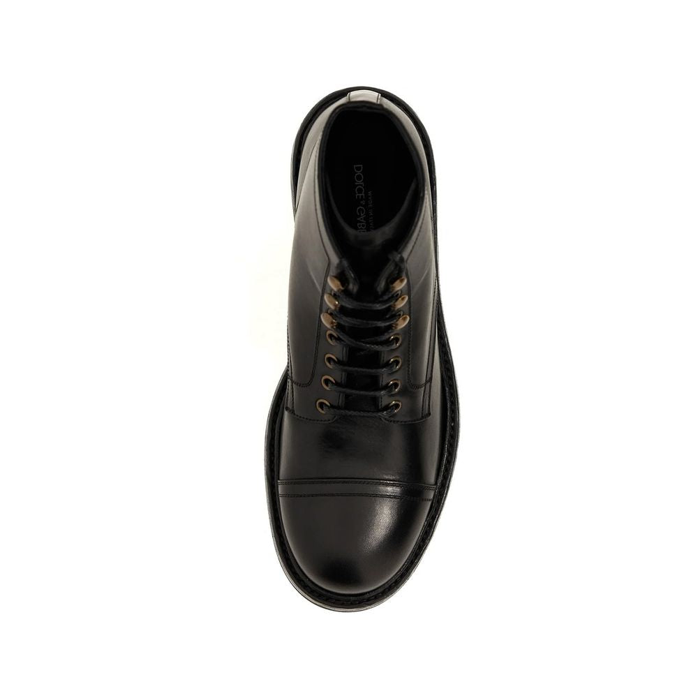 Black leather boot with a white sole on a white background