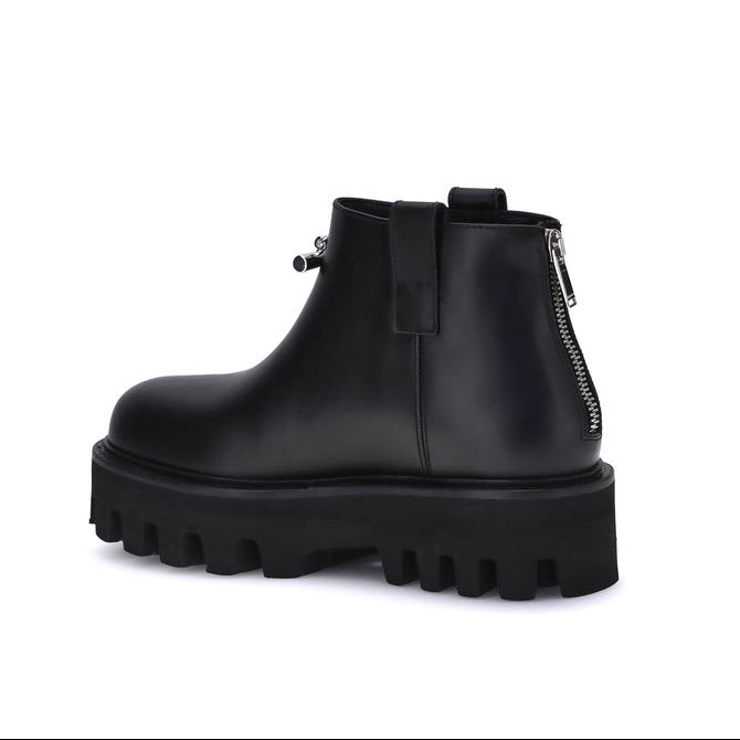 Black platform ankle boot on a white background