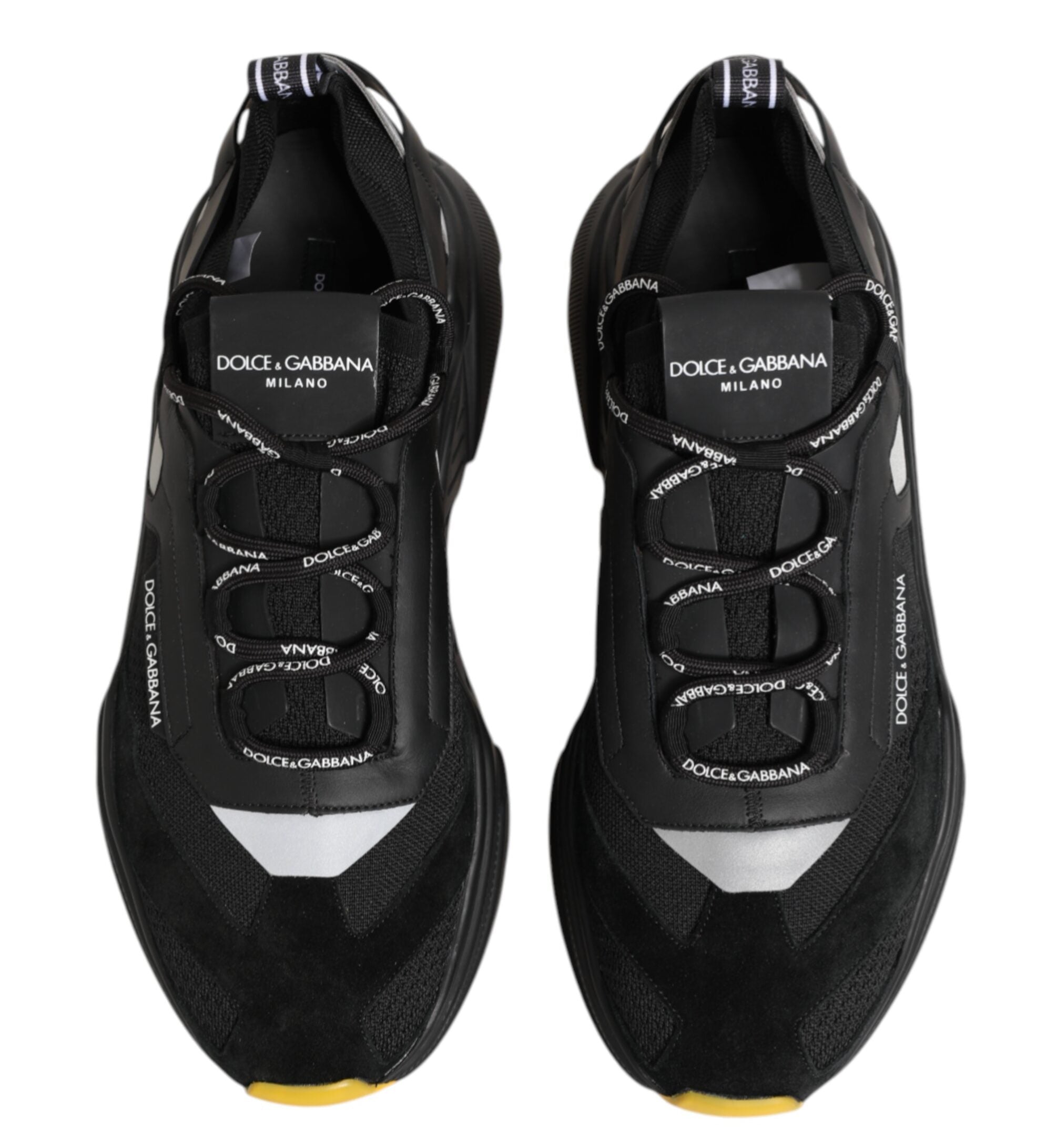 Black Dolce & Gabbana sneakers with yellow sole on a white background