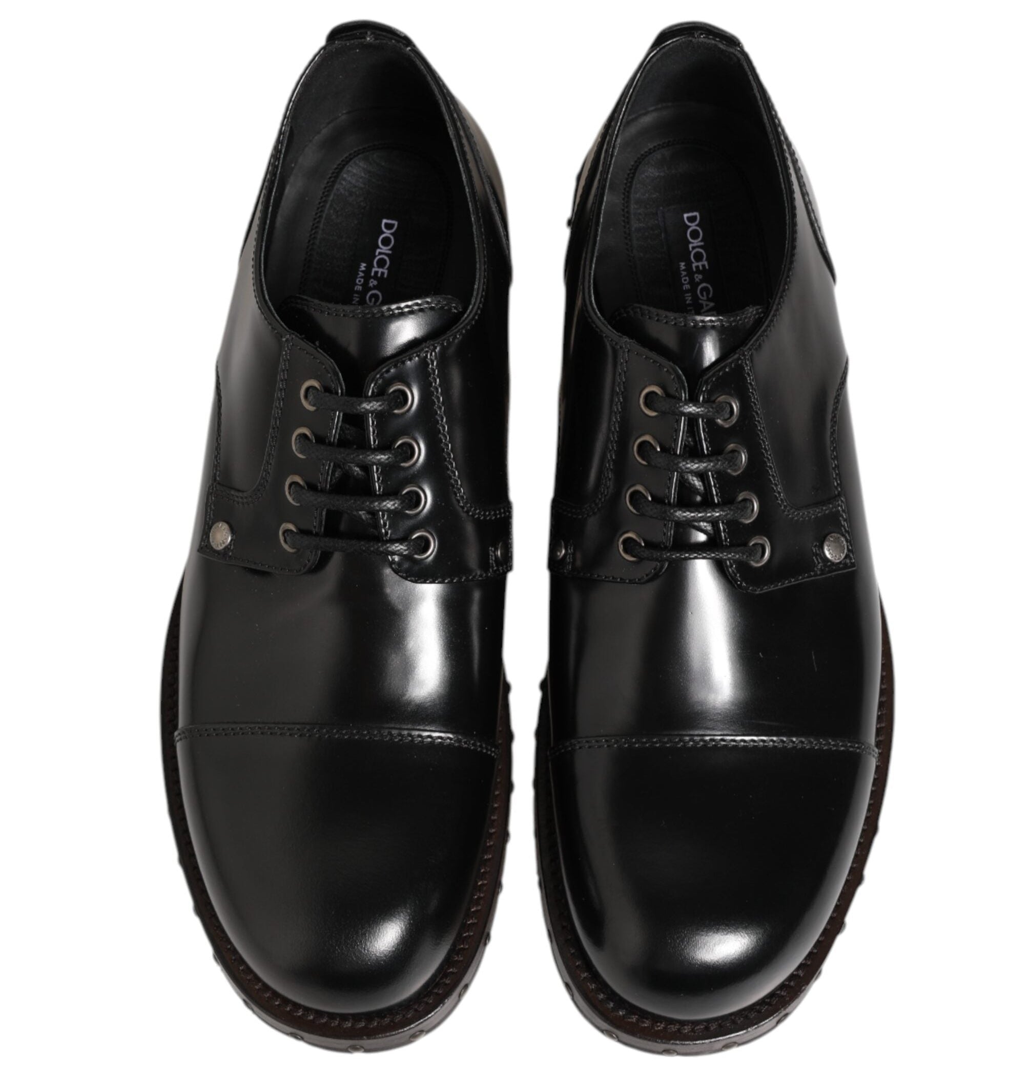 Pair of black leather dress shoes on a white background