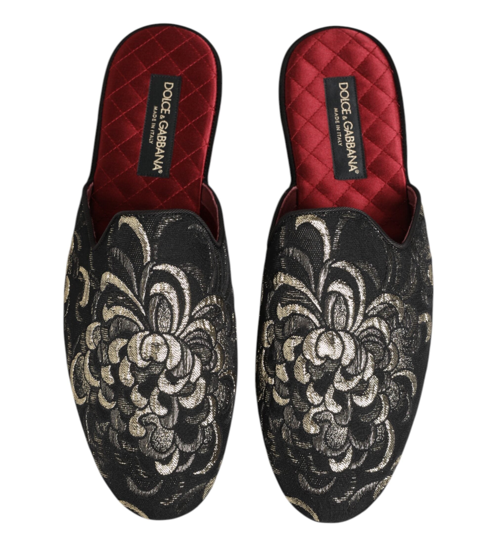 Pair of Dolce & Gabbana slippers with floral embroidery on a white background
