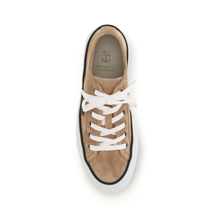 Brown sneaker with white laces on a white background