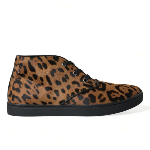 A pair of Dolce & Gabbana mid-top sneakers with a brown leopard print pattern and black lace-up closure.