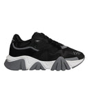 A pair of black leather mesh chunky low-top sneakers with a lace-up closure and white sole.