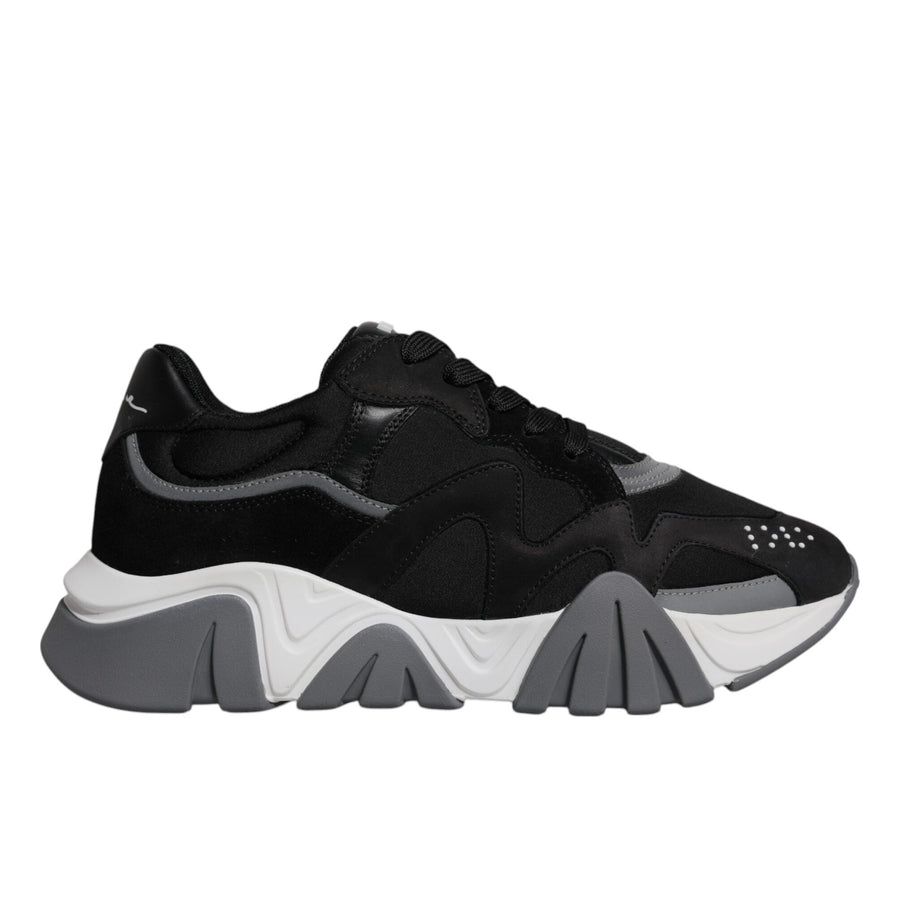 A pair of black leather mesh chunky low-top sneakers with a lace-up closure and white sole.