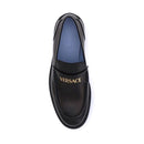 Black Versace loafer on a white background
