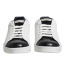 White sneakers with black soles on a white background