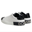 White sneakers with black accents and Dolce & Gabbana branding on a white background