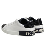 White sneakers with black accents and Dolce & Gabbana branding on a white background