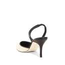 High-heeled shoe with a black strap on a white background