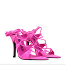 Pink high-heeled strappy shoes on a white background