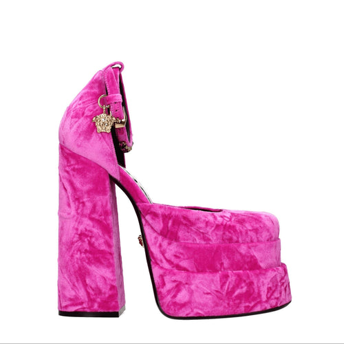 Pink high-heeled platform shoe on a white background