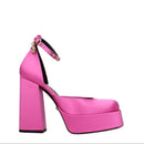 Pink high-heeled platform shoe on a white background