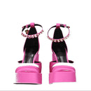 Pink high-heeled sandals with platform sole on a white background