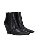 Black shiny ankle boots on a white background