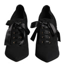 Black shoes with ribbons on a white background