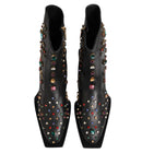 Black studded shoes with colorful gemstones on a white background