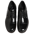 Pair of black leather dress shoes on a white background