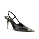 Black high-heeled shoe with metallic tip on a white background