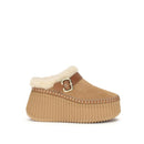 Tan platform slipper with white fur lining on a white background